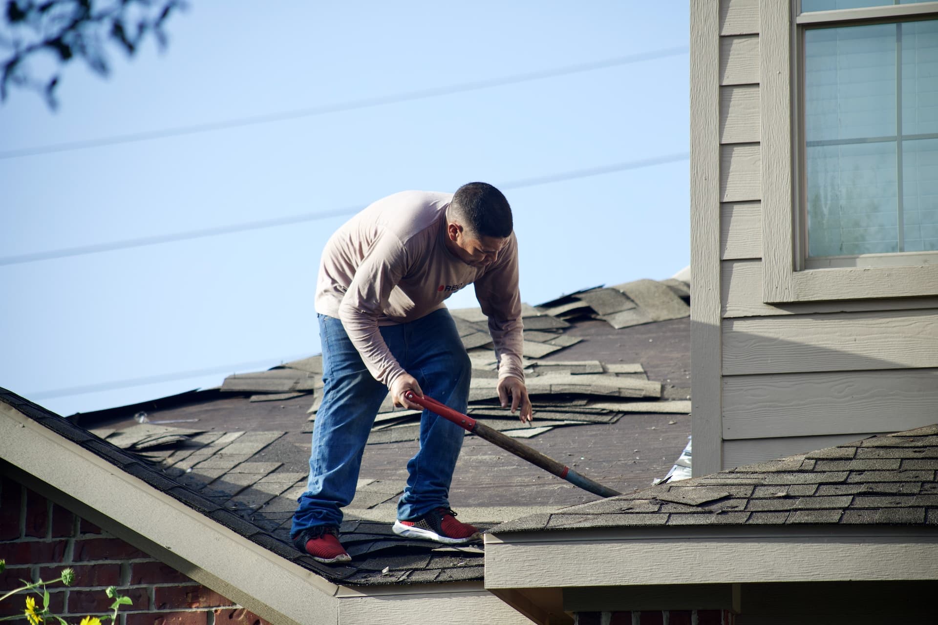 Roofing professional doing roof repair and routine maintenance tasks. Fortress Roofing Calgary