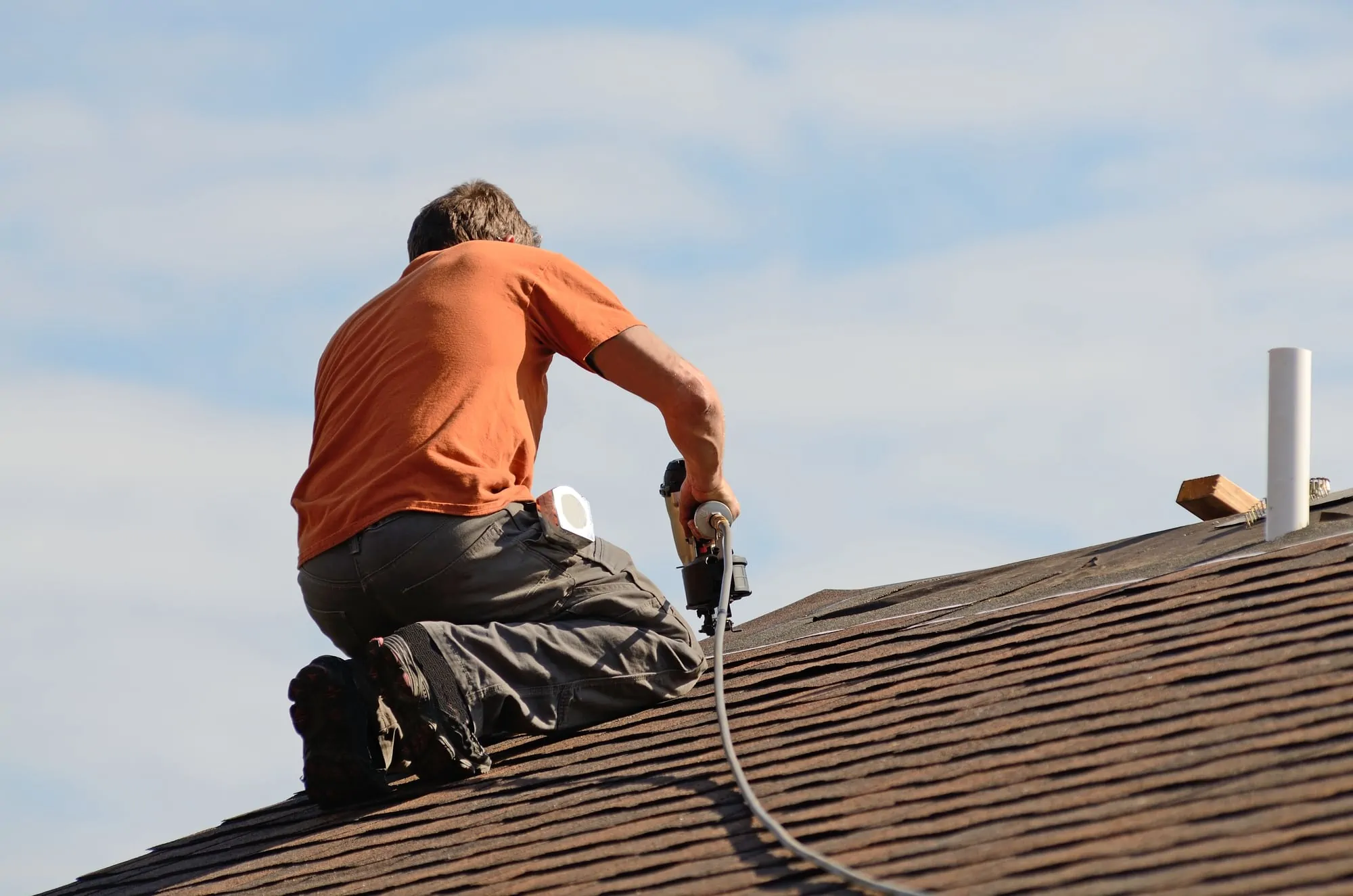 A man installing a roof.